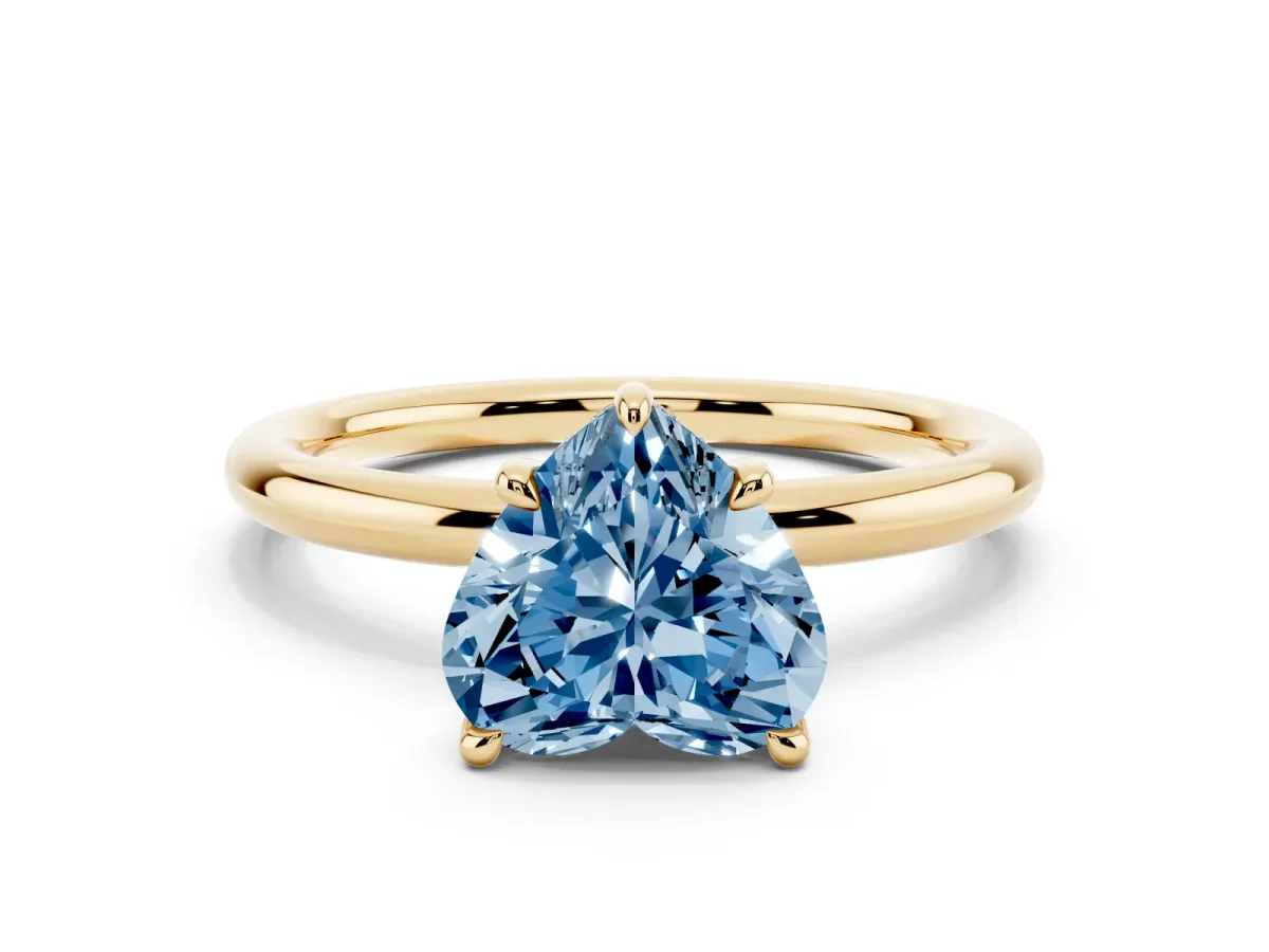 Fancy Blue Heart Cut Diamond Solitaire Ring with Thin Band and Four-Prong Setting Yellow gold