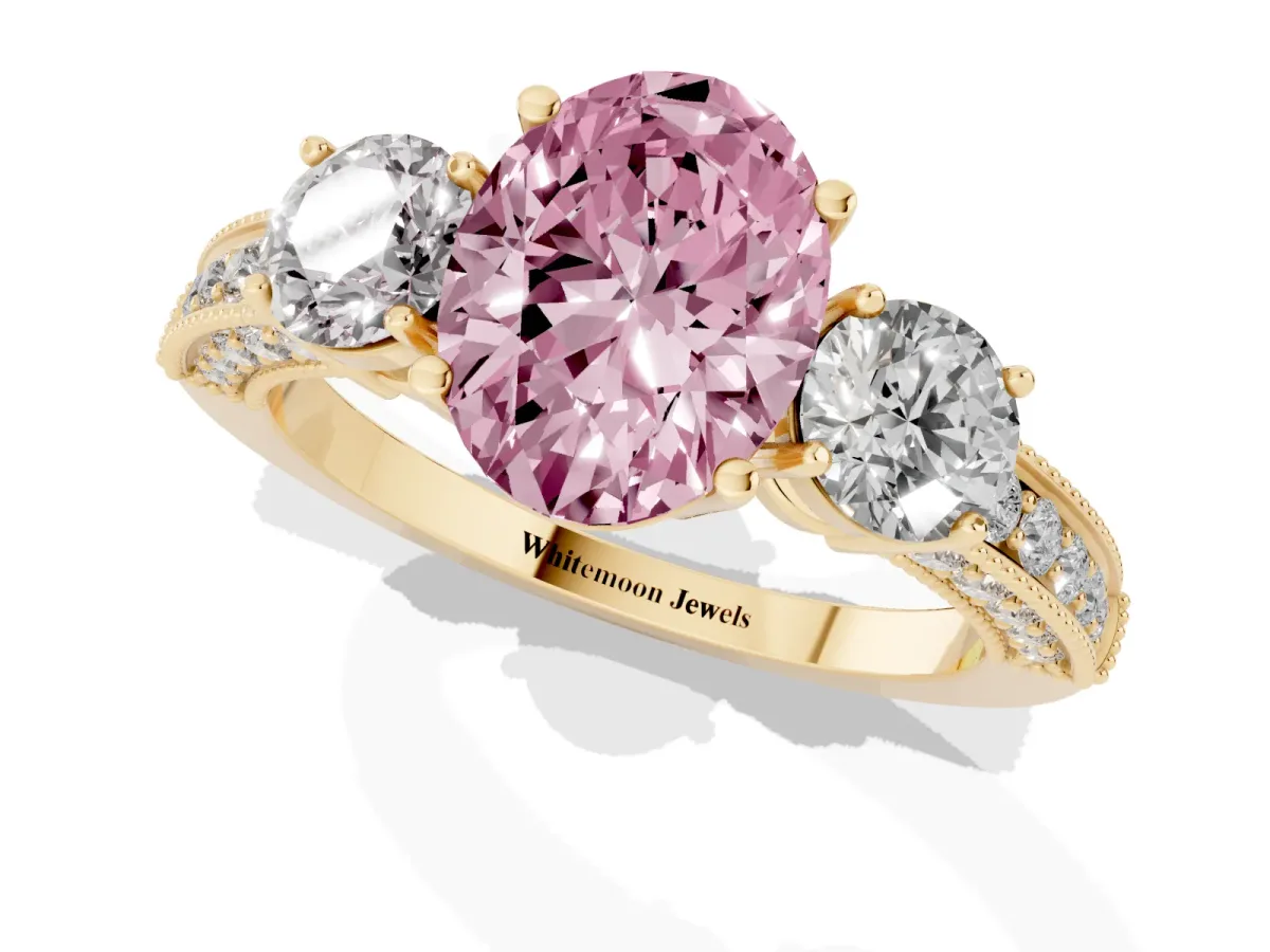 Fancy Pink Oval Cut Three-Stone Diamond Ring with Pavé Band and Four-Prong Setting Yellow gold