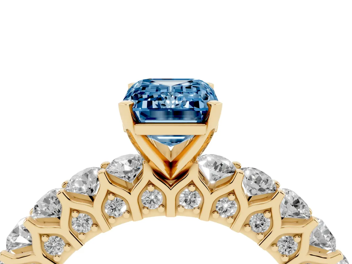 Fancy Blue Emerald Cut Diamond Solitaire Ring with Shared Prong Pavé Band and Four-Prong Setting Yellow gold