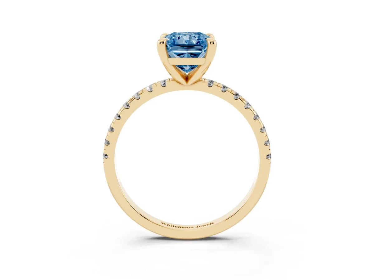 Fancy Blue Radiant Cut Diamond Brilliant Solitaire Ring with Pavé Band and Four-Prong Setting Yellow gold