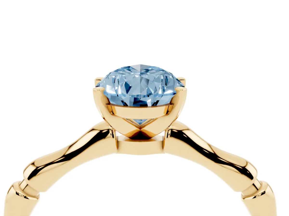 Fancy Blue Pear Cut Solitaire Diamond Ring with Bamboo Band and Four-Prong Setting Yellow gold