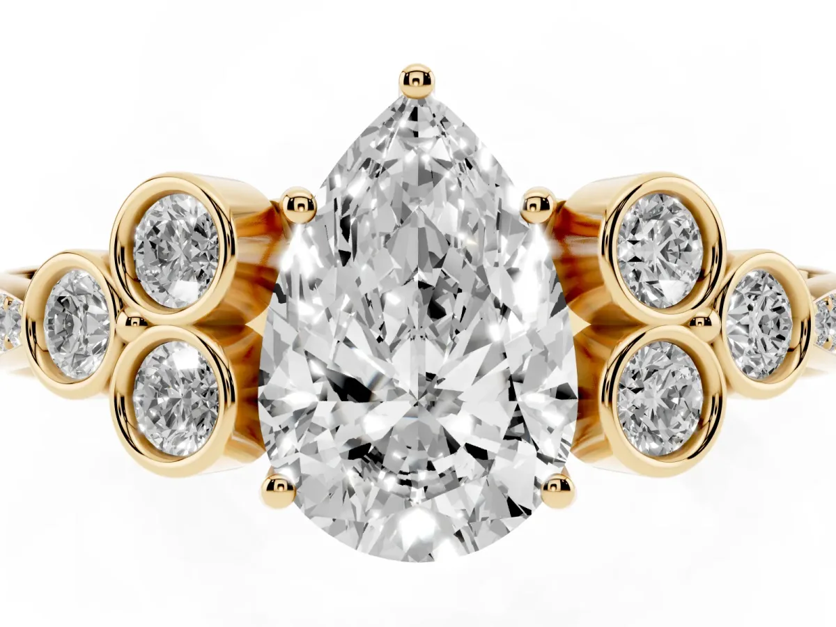 Pear Cut Cut Diamond Engagement Ring with Bezel Set Round Side Stones and Prong Setting Yellow gold