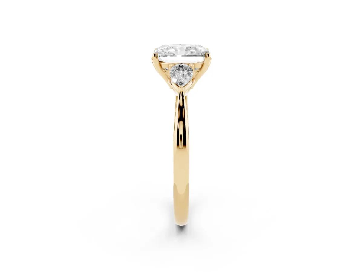 Radiant Cut Diamond Three-Stone Ring with Pear Side Stones and Prong Setting Yellow gold