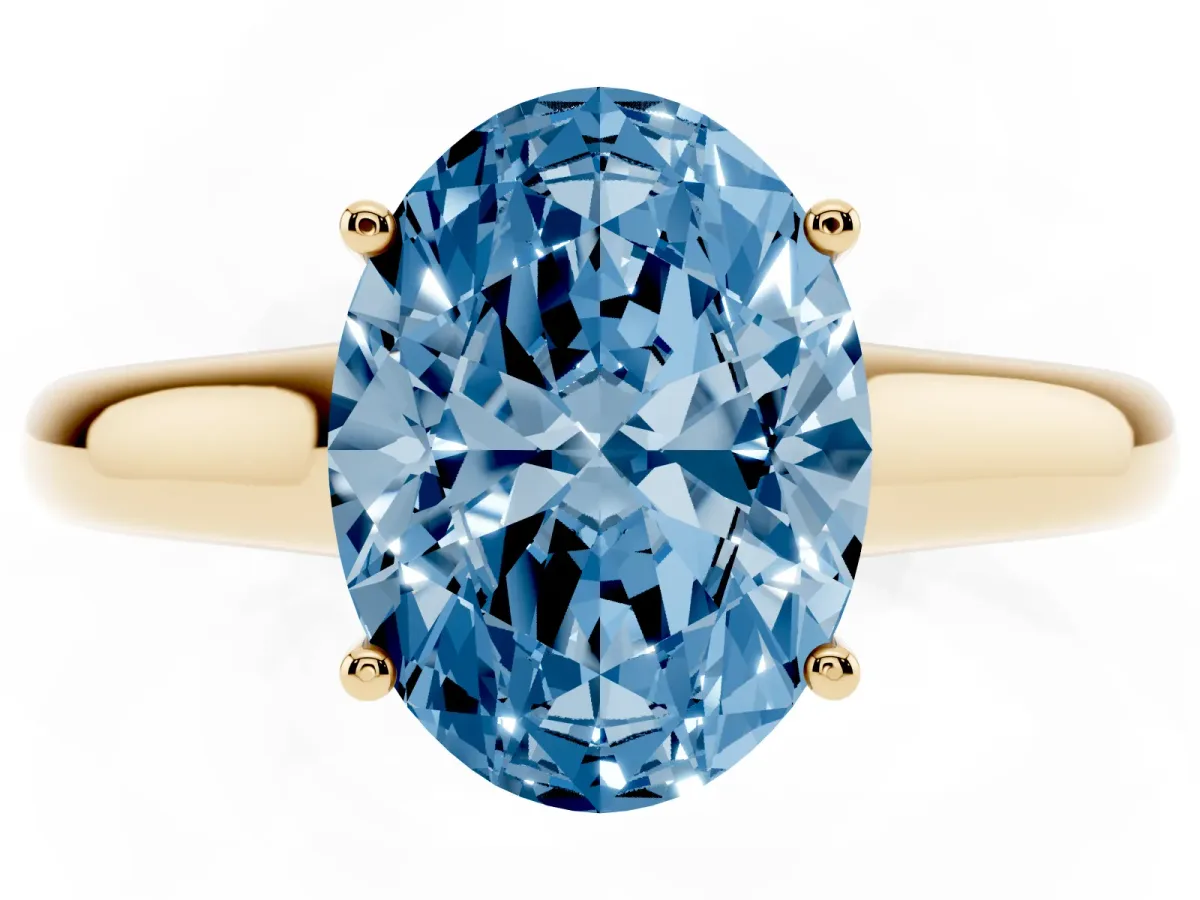 Fancy Blue Oval Cut Solitaire Engagement Ring with Tapered Band and Four-Prong Setting Yellow gold
