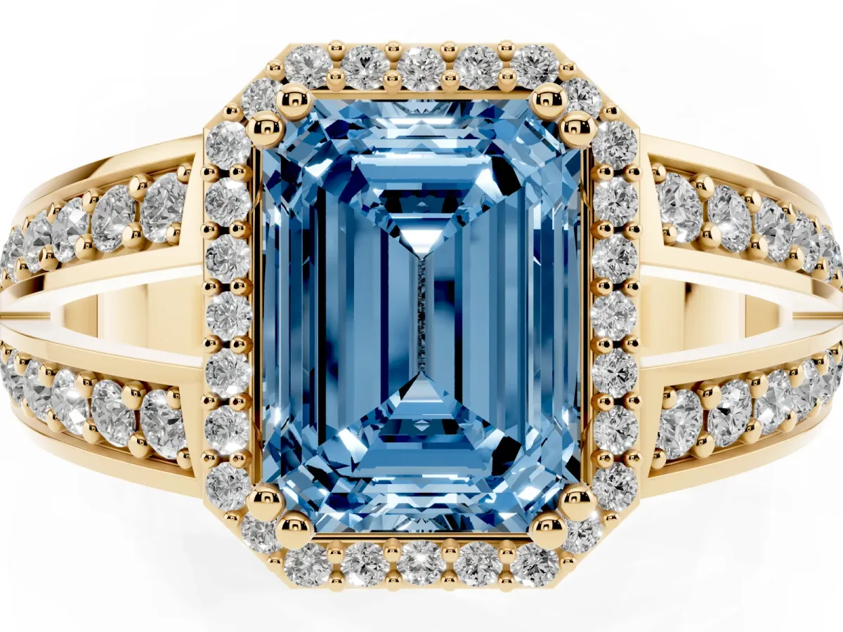 Fancy Blue Emerald Cut Diamond Halo Ring with Split Shank Pavé Band and Four-Prong Setting Yellow gold