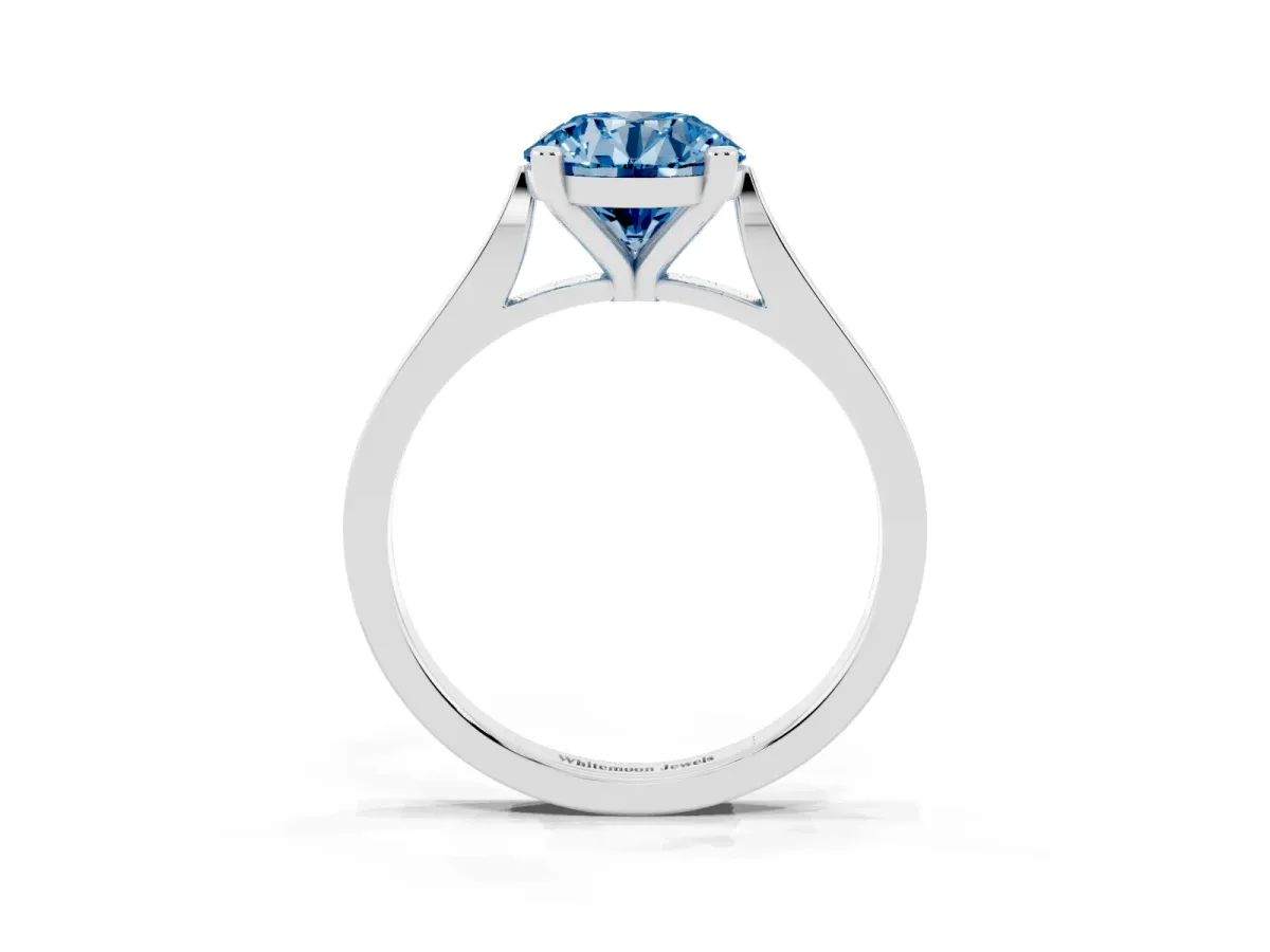 Fancy Blue Round Cut Solitaire Diamond Ring with Four-Prong Setting and Tapered Band Platinum