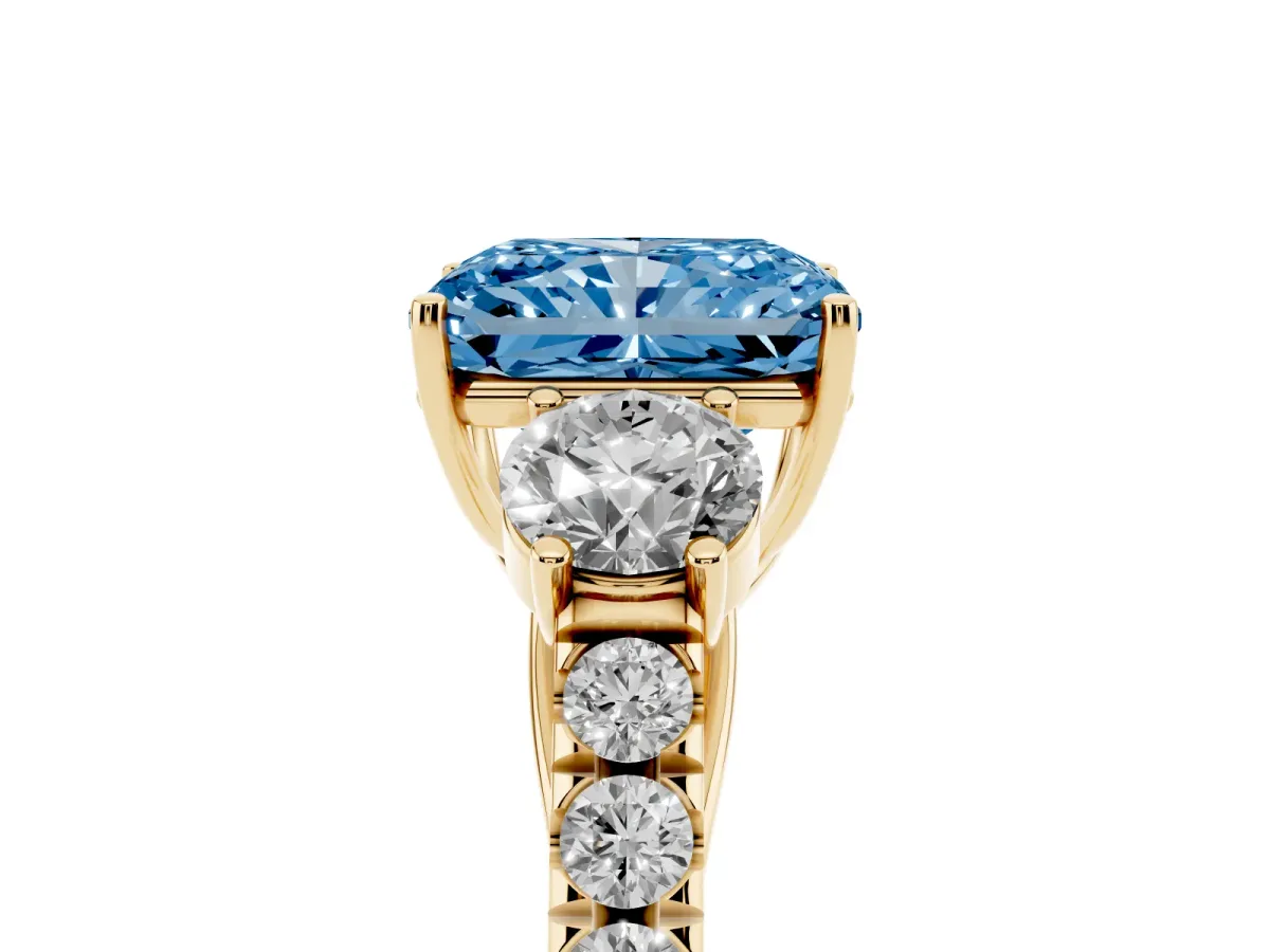 Fancy Blue Radiant Cut Cut Diamond Three-Stone Ring with Round Side Stones and Pavé Band Yellow gold