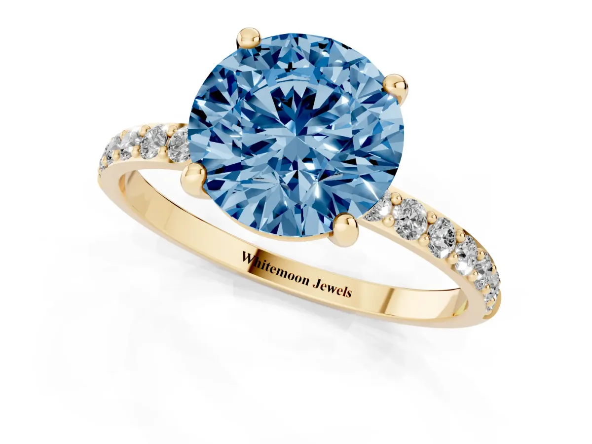 Fancy Blue Round Cut Diamond Solitaire Ring with Round Pavé Band and Prong Setting Yellow gold