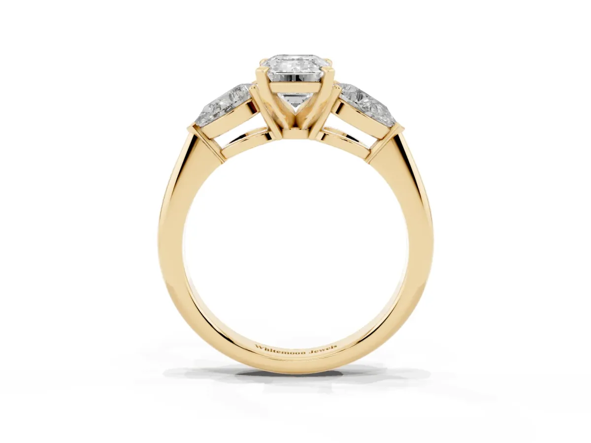 Three-Stone Emerald Cut Diamond Ring with Pear Side Stones and Four-Prong Setting Yellow gold