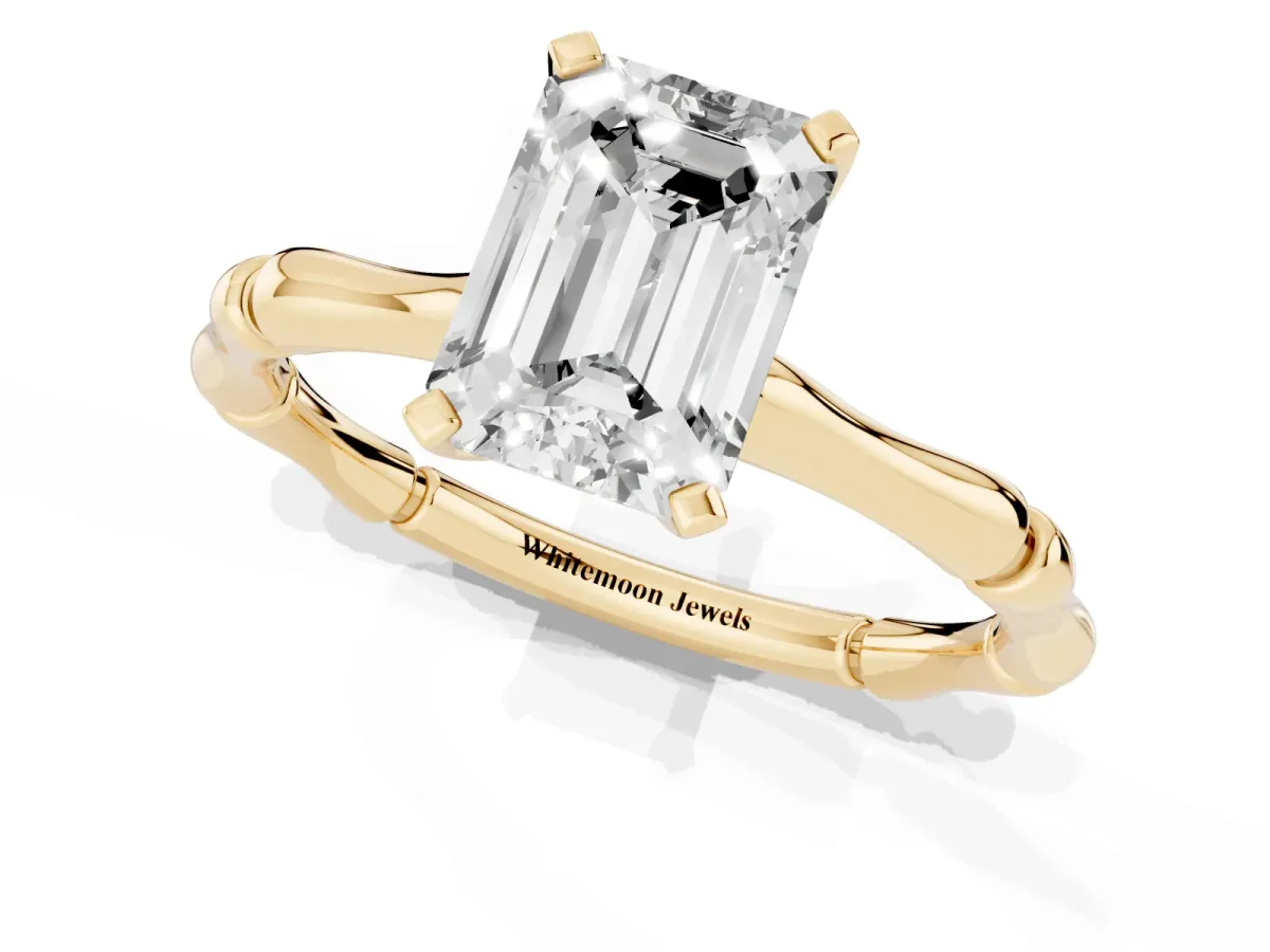 Emerald Cut Solitaire Diamond Ring with Bamboo Band and Four-Prong Setting Yellow gold