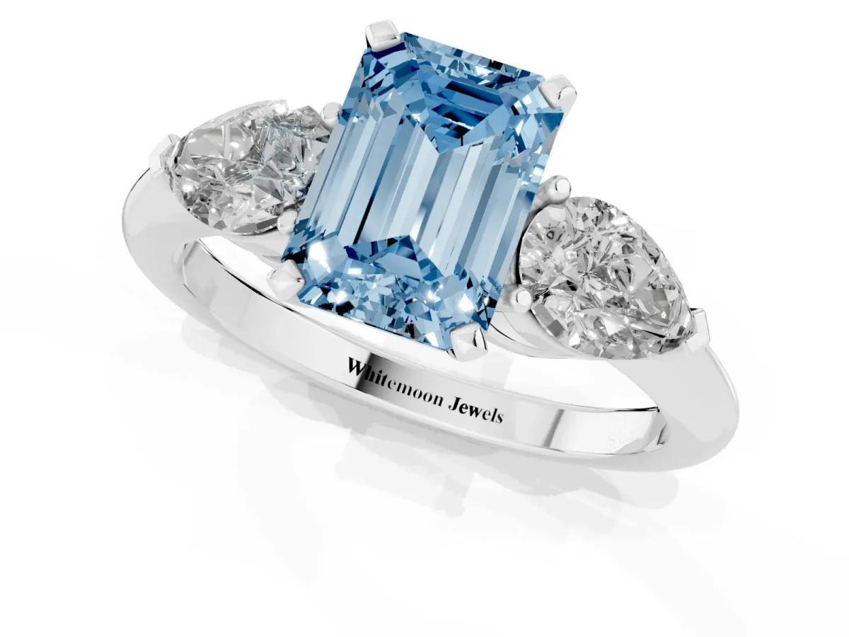 Fancy Blue Three-Stone Emerald Cut Diamond Ring with Pear Side Stones and Four-Prong Setting Platinum