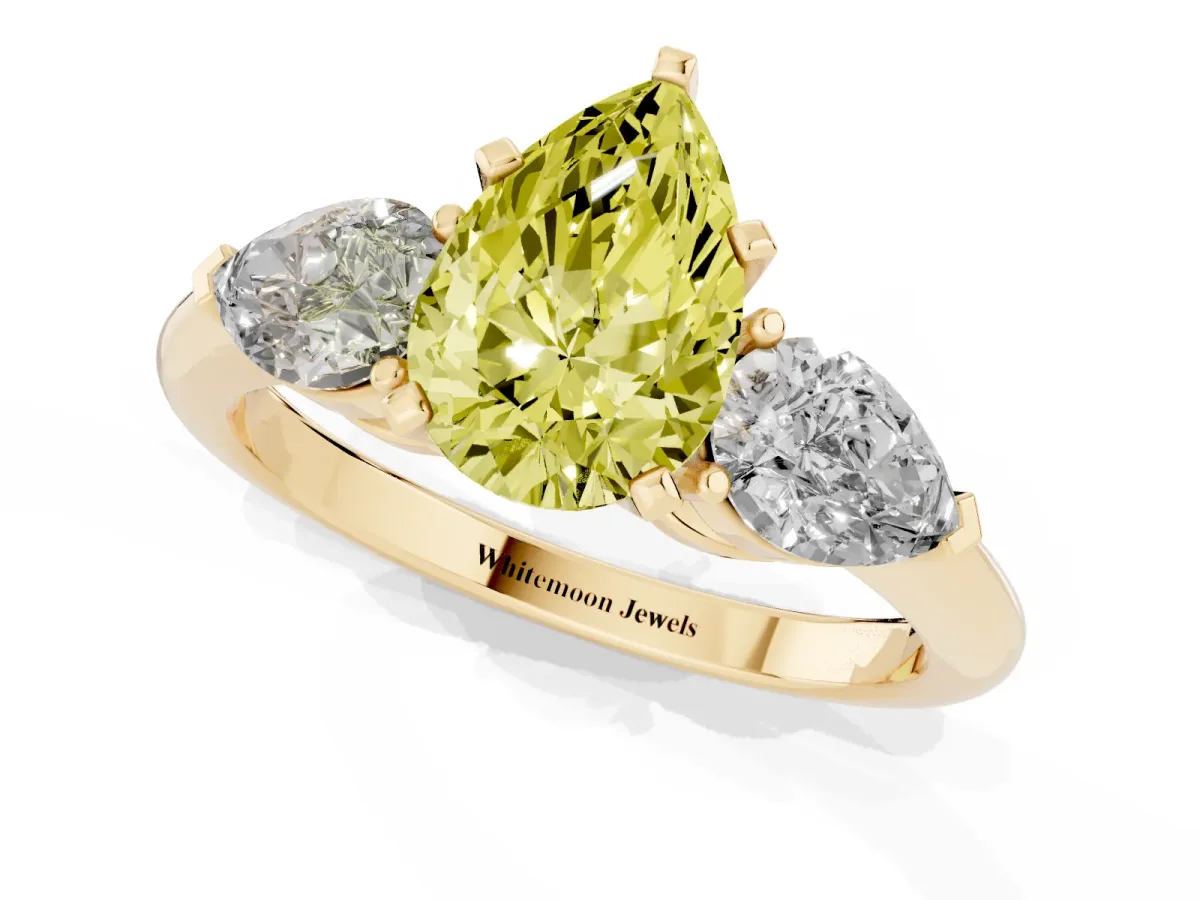 Fancy Yellow Three-Stone Pear Cut Diamond Ring with Pear Side Stones and Four-Prong Setting Yellow gold