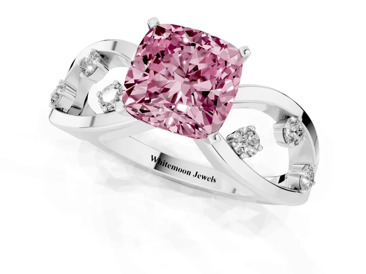 Fancy Pink Cushion Cut Cut Solitaire Diamond with Side Stones on Criss-Cross Band and Four-Prong Setting Platinum