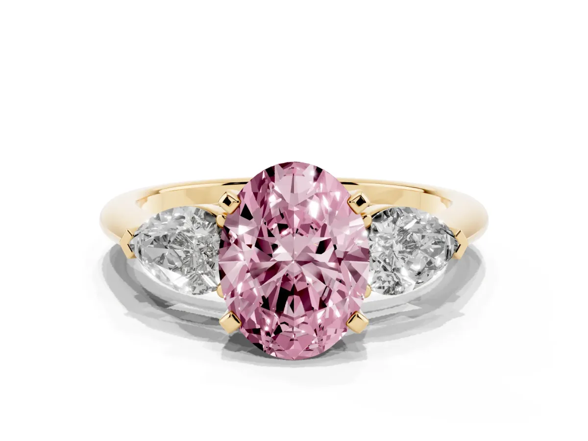 Fancy Pink Three-Stone Oval Cut Diamond Ring with Pear Side Stones and Four-Prong Setting Yellow gold
