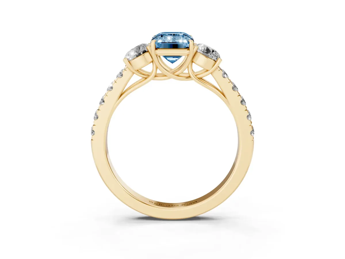 Fancy Blue Emerald Cut Cut Diamond Three-Stone Ring with Round Side Stones and Pavé Band Yellow gold