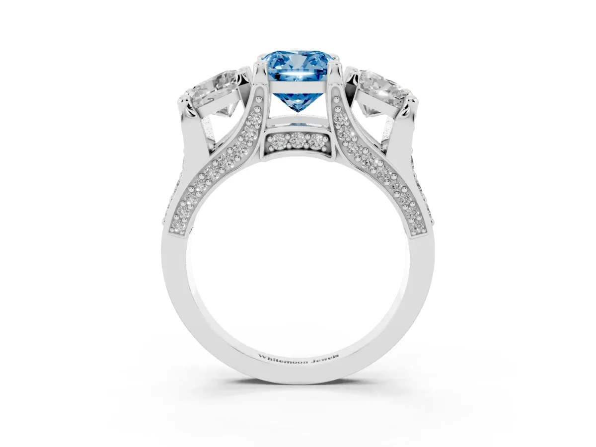 Fancy Blue Cushion Cut Diamond Three-Stone Ring with Channel Set Band and Four-Prong Setting White gold