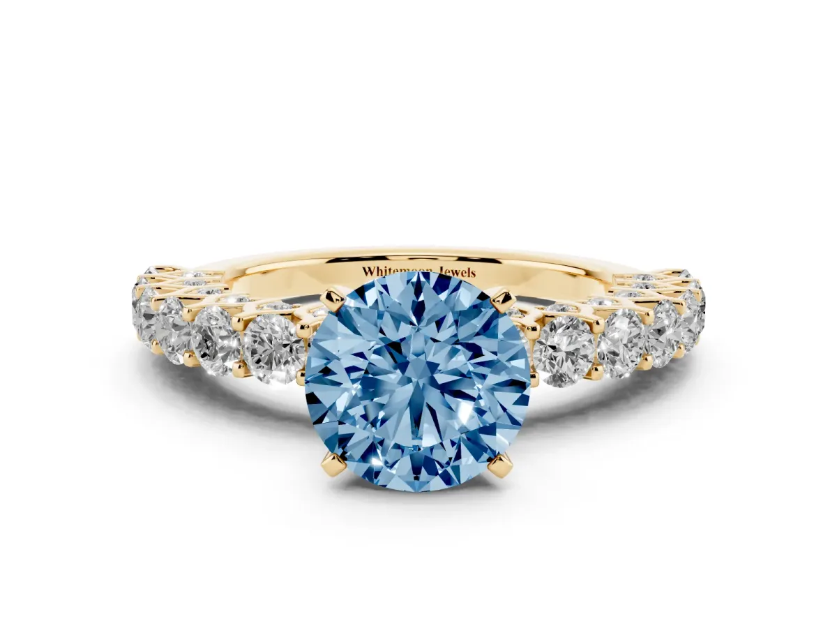 Fancy Blue Round Cut Diamond Solitaire Ring with Shared Prong Pavé Band and Four-Prong Setting Yellow gold