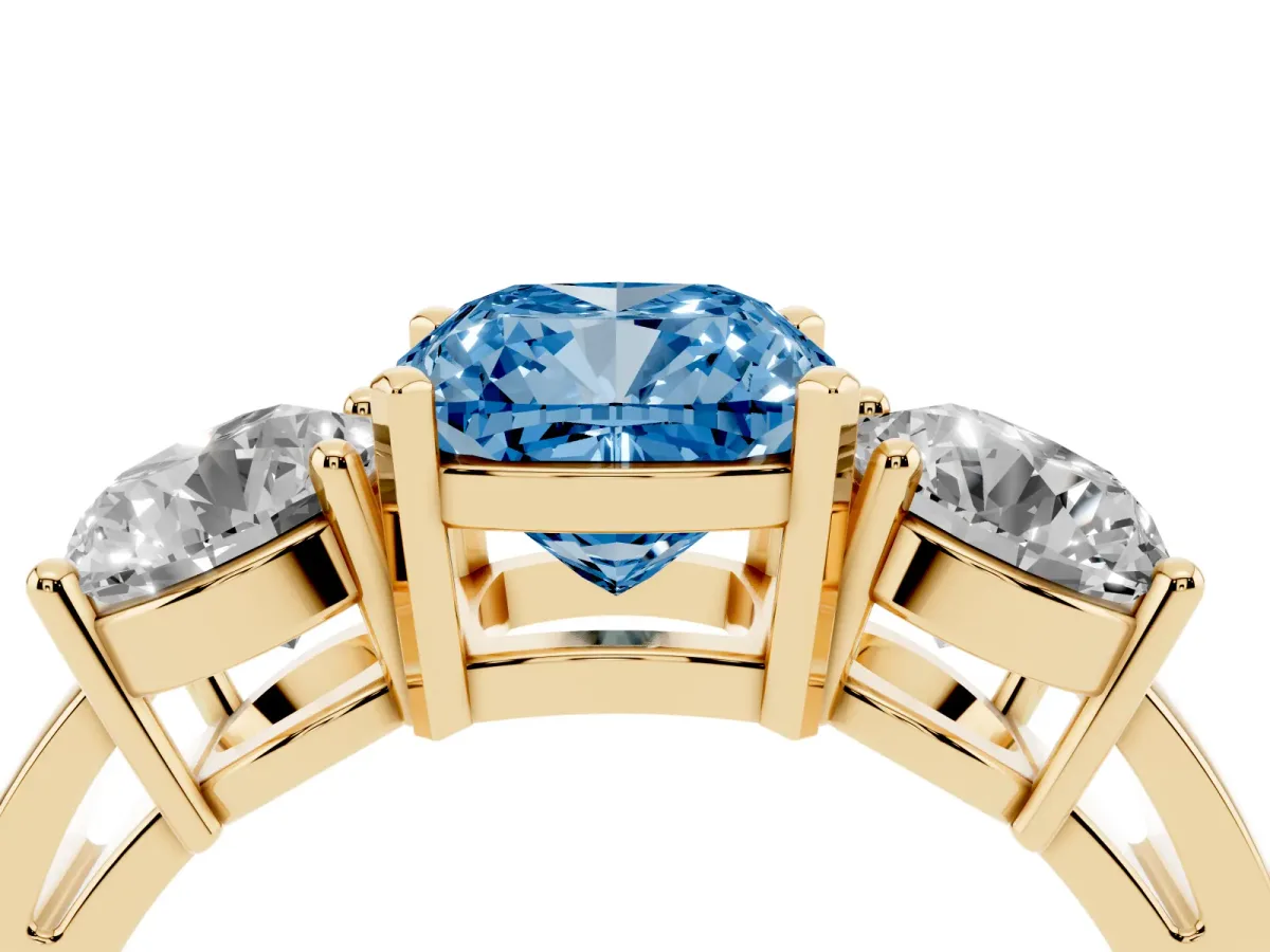 Fancy Blue Three-Stone Cushion Cut Diamond Ring with Round Side Stones, Classic Band, and Four-Prong Setting Yellow gold