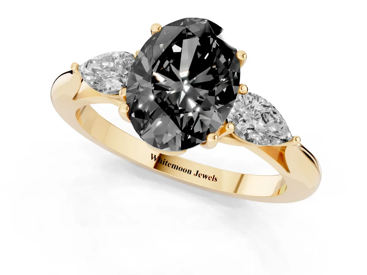Fancy Black Oval Cut Diamond Three-Stone Ring with Pear Side Stones and Prong Setting Yellow gold