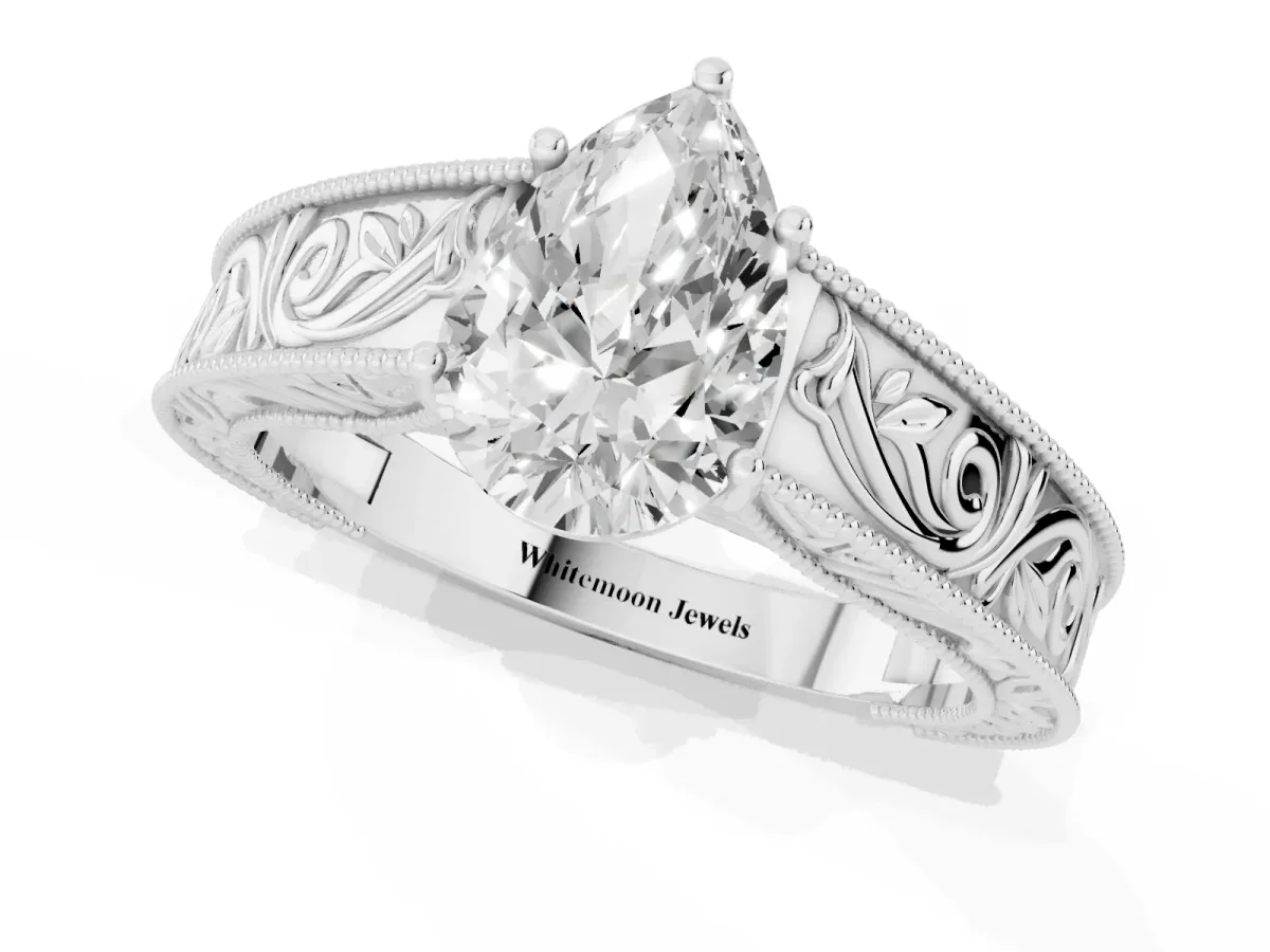 Pear Cut Diamond Solitaire Ring with Engraved Band and Four-Prong Setting Silver