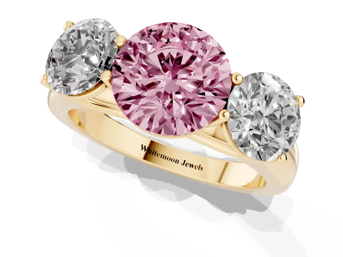 Fancy Pink Round Cut Three-Stone Diamond Ring with Prong Setting on a Classic Band Yellow gold