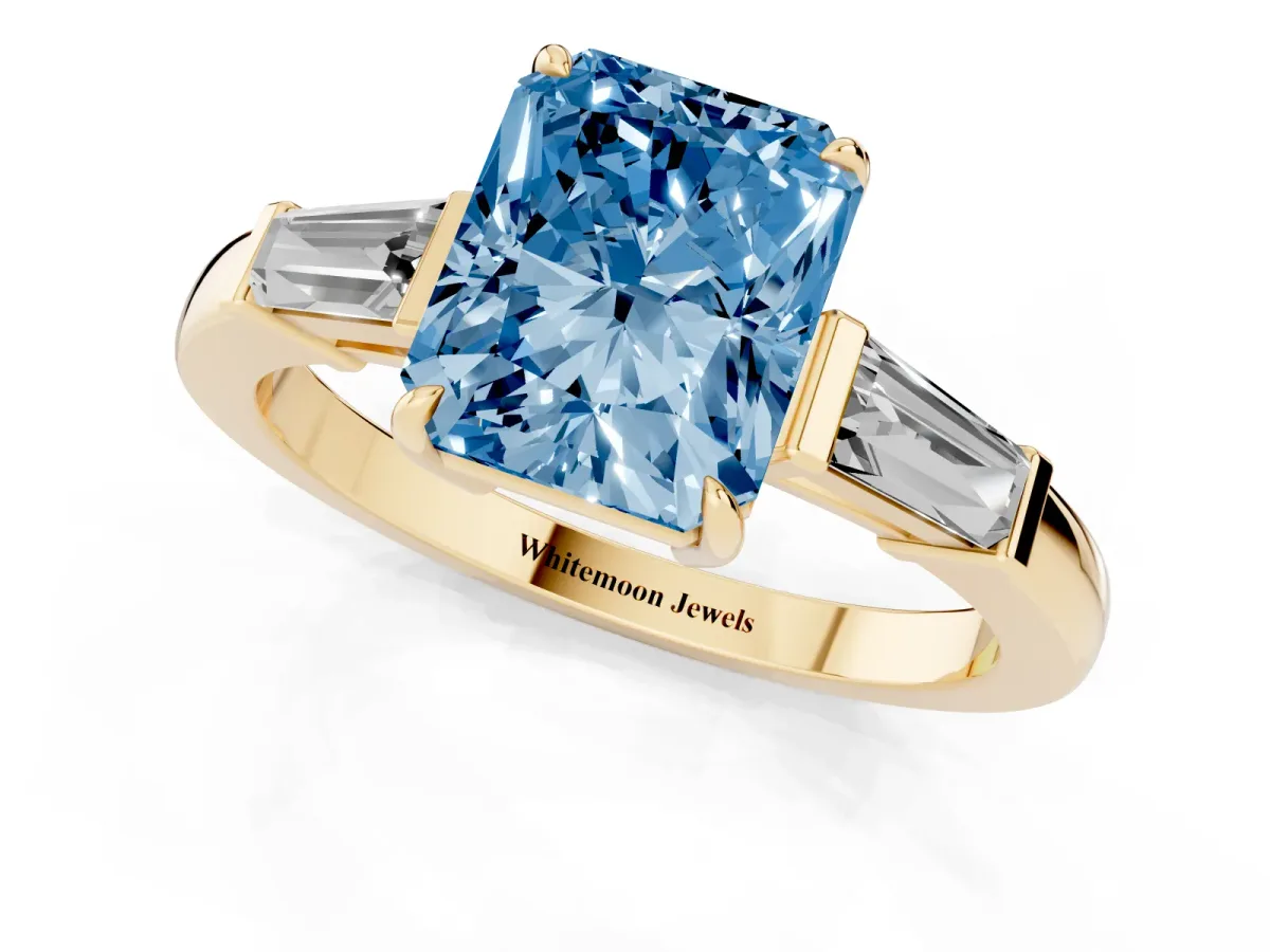 Fancy Blue Radiant Cut Diamond Three-Stone Ring with Tapered Baguette Side Stones and Prong Setting Yellow gold