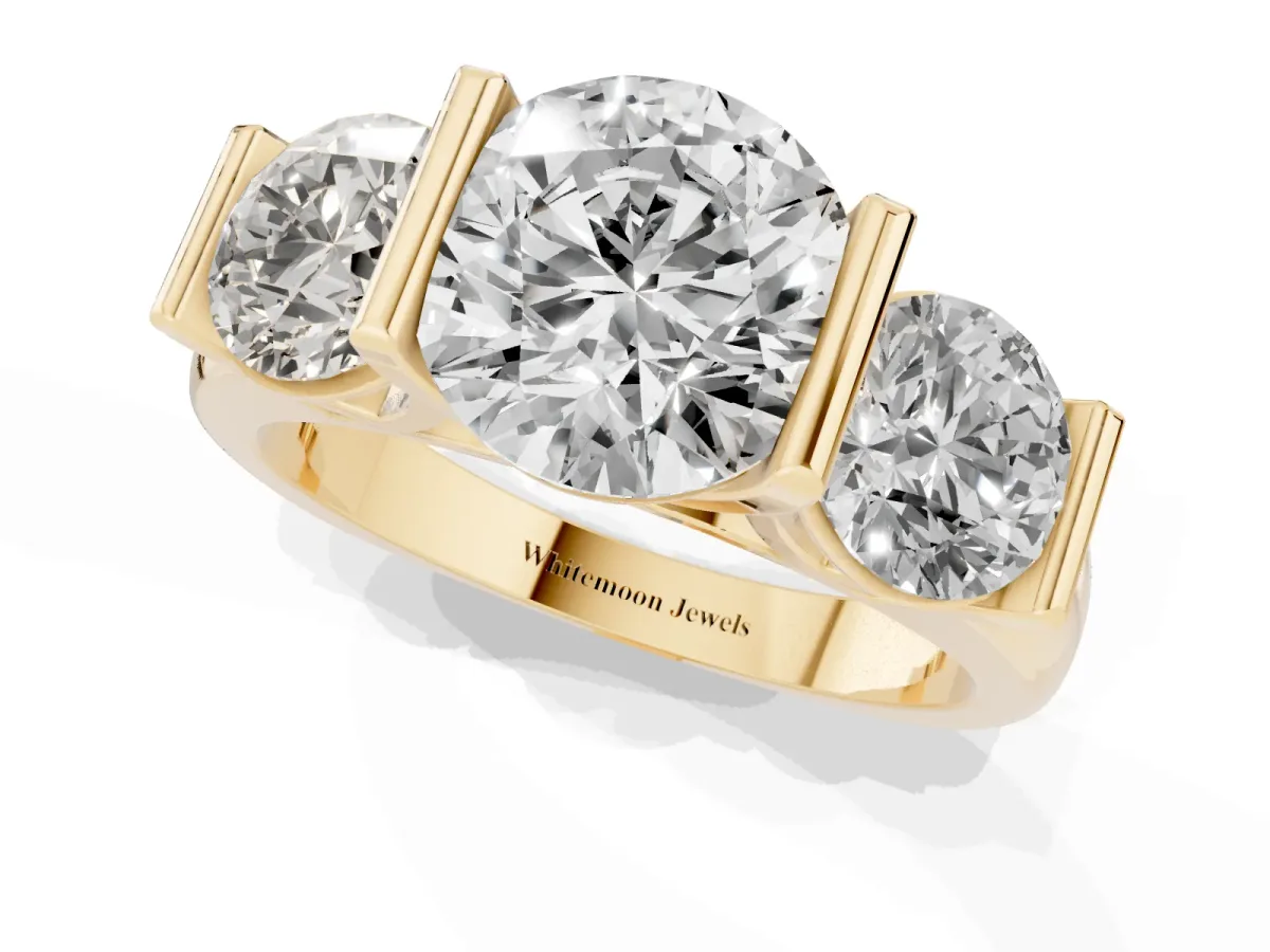 Three-Stone Round Cut Brilliant Diamond Ring with Channel Setting and White Gold Band Yellow gold