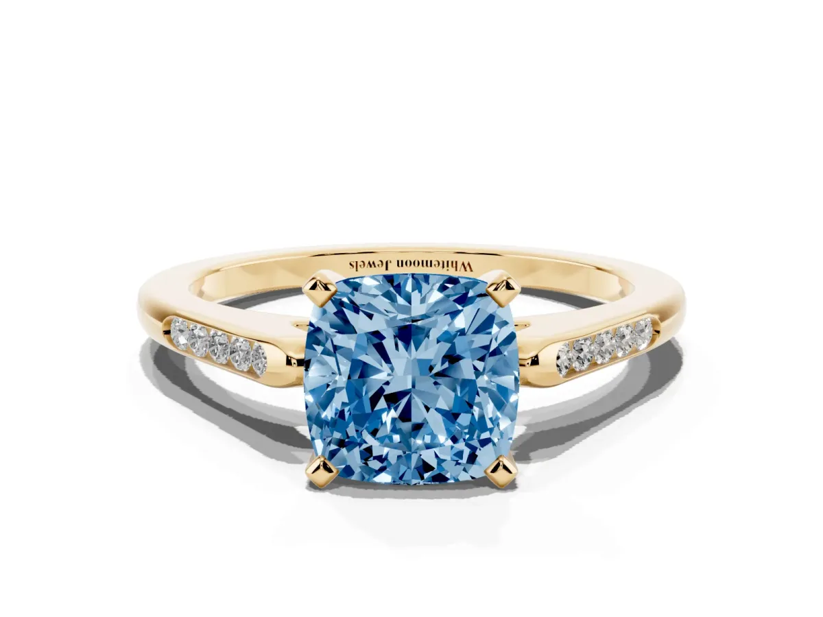 Fancy Blue Cushion Cut Diamond Solitaire Ring with Channel Set Round Band and Prong Setting Yellow gold