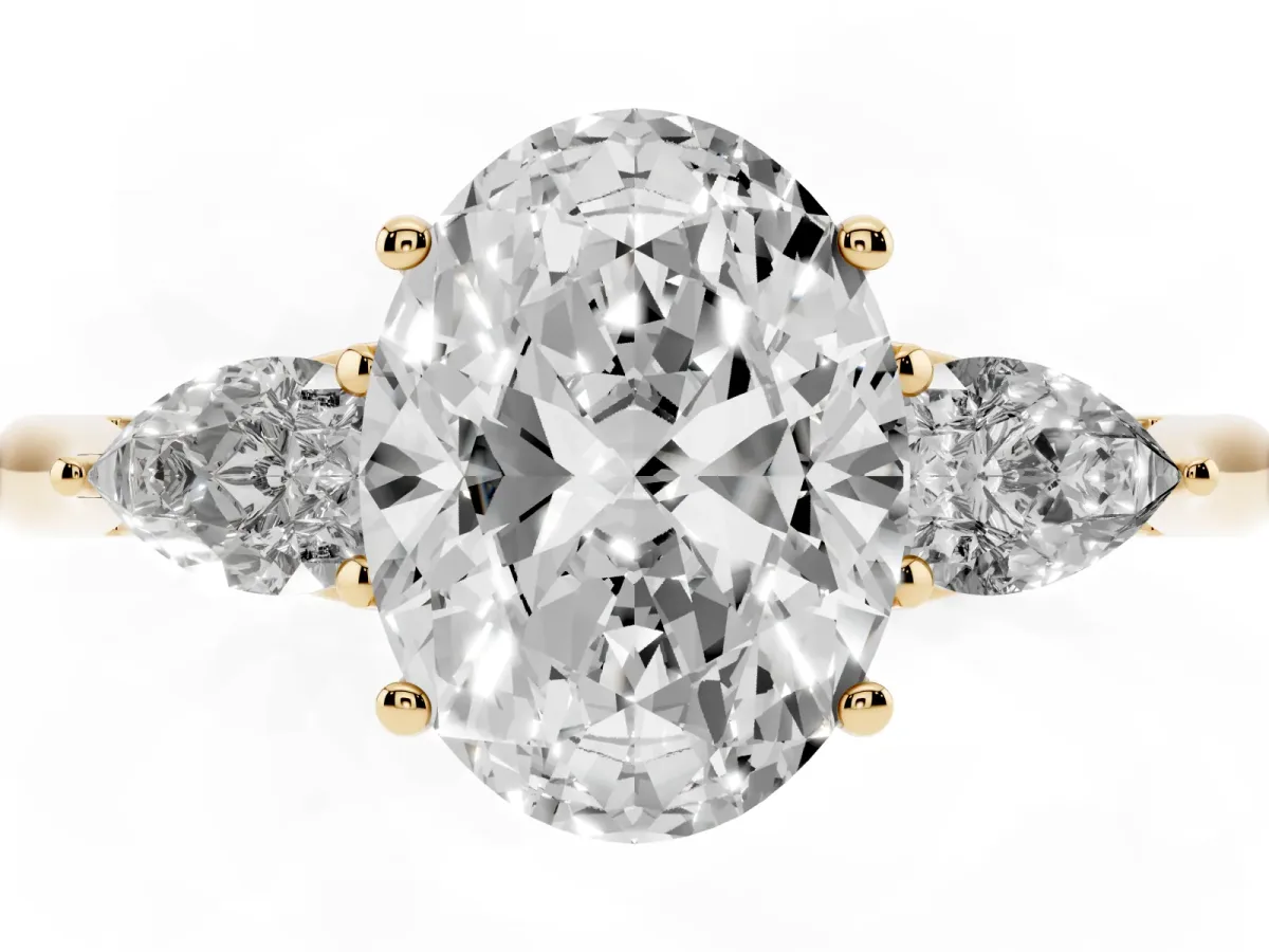 Oval Cut Diamond Three-Stone Ring with Pear Side Stones and Prong Setting Yellow gold