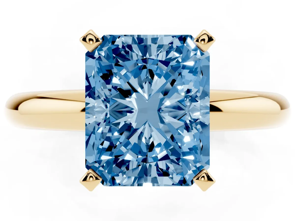 Fancy Blue Radiant Cut Diamond Solitaire Engagement Ring with Round Band and Four-Prong Setting Yellow gold
