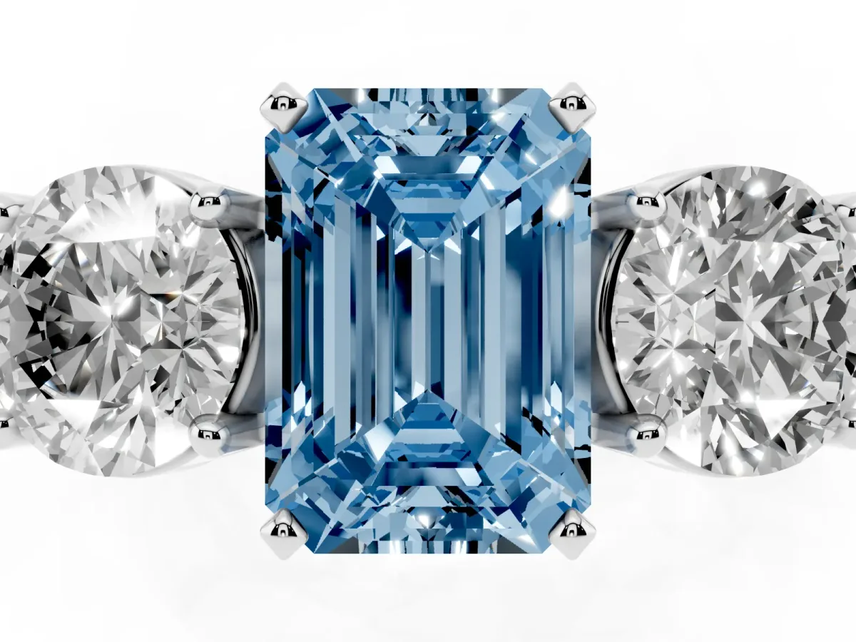 Fancy Blue Three-Stone Emerald Cut Diamond Ring with Round Side Stones, Classic Band, and Four-Prong Setting Silver