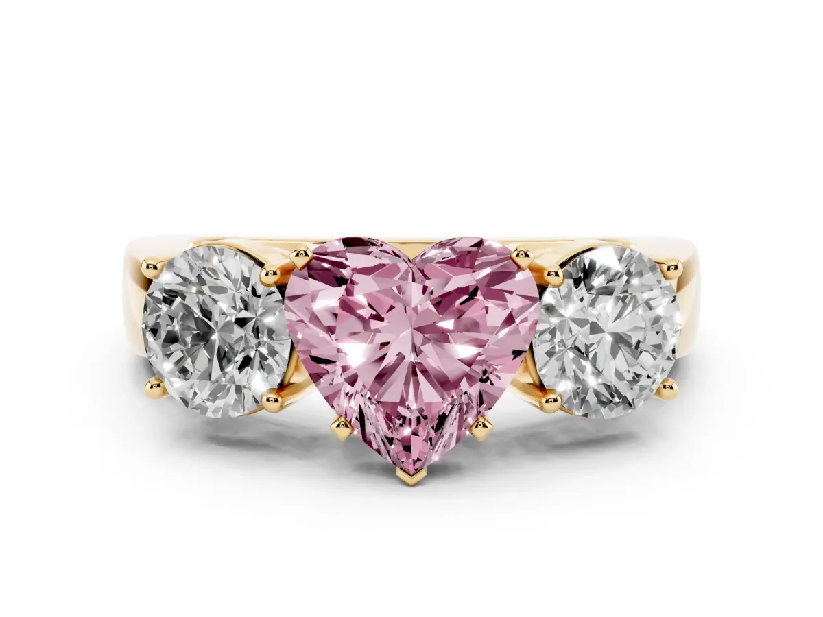 Fancy Pink Three-Stone Heart Cut Diamond Ring with Round Side Stones, Classic Band, and Four-Prong Setting Yellow gold