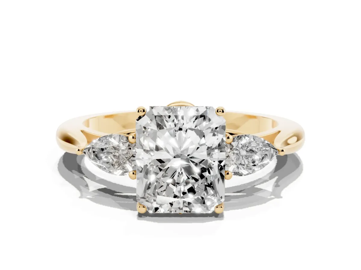 Three-Stone Radiant Cut Diamond Ring with Pear Side Stones in Four-Prong Setting Yellow gold