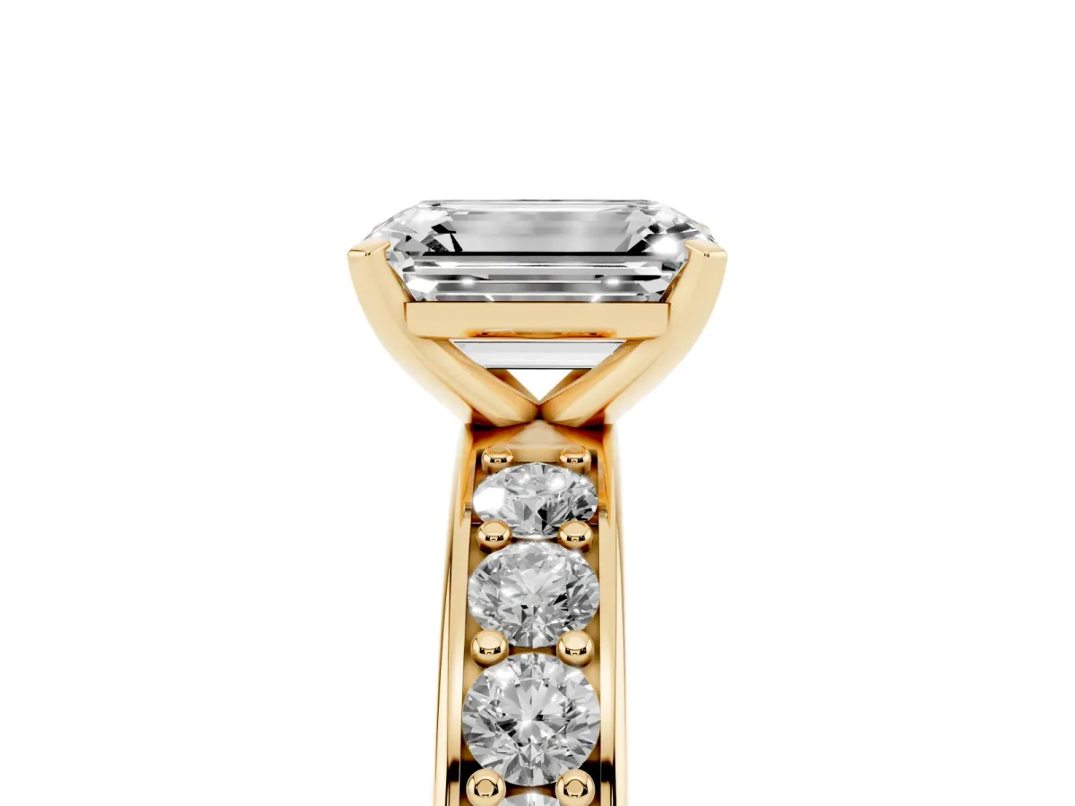 Emerald Cut Diamond Engagement Ring with Channel Set Round Band and Prong Setting Yellow gold