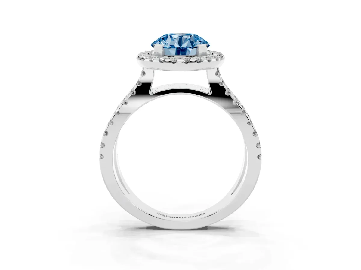 Fancy Blue Round Cut Diamond Halo Ring with Split Shank Pavé Band and Prong Setting Silver