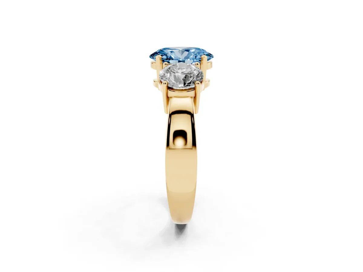 Fancy Blue Three-Stone Oval Cut Diamond Ring with Round Side Stones, Classic Band, and Four-Prong Setting Yellow gold