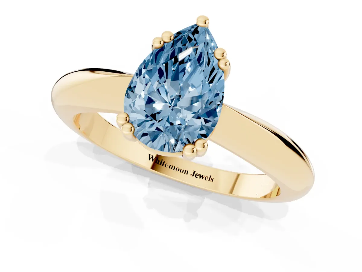 Fancy Blue Pear Cut Cut Solitaire Engagement Ring with Tapered Band and Four-Prong Setting Yellow gold