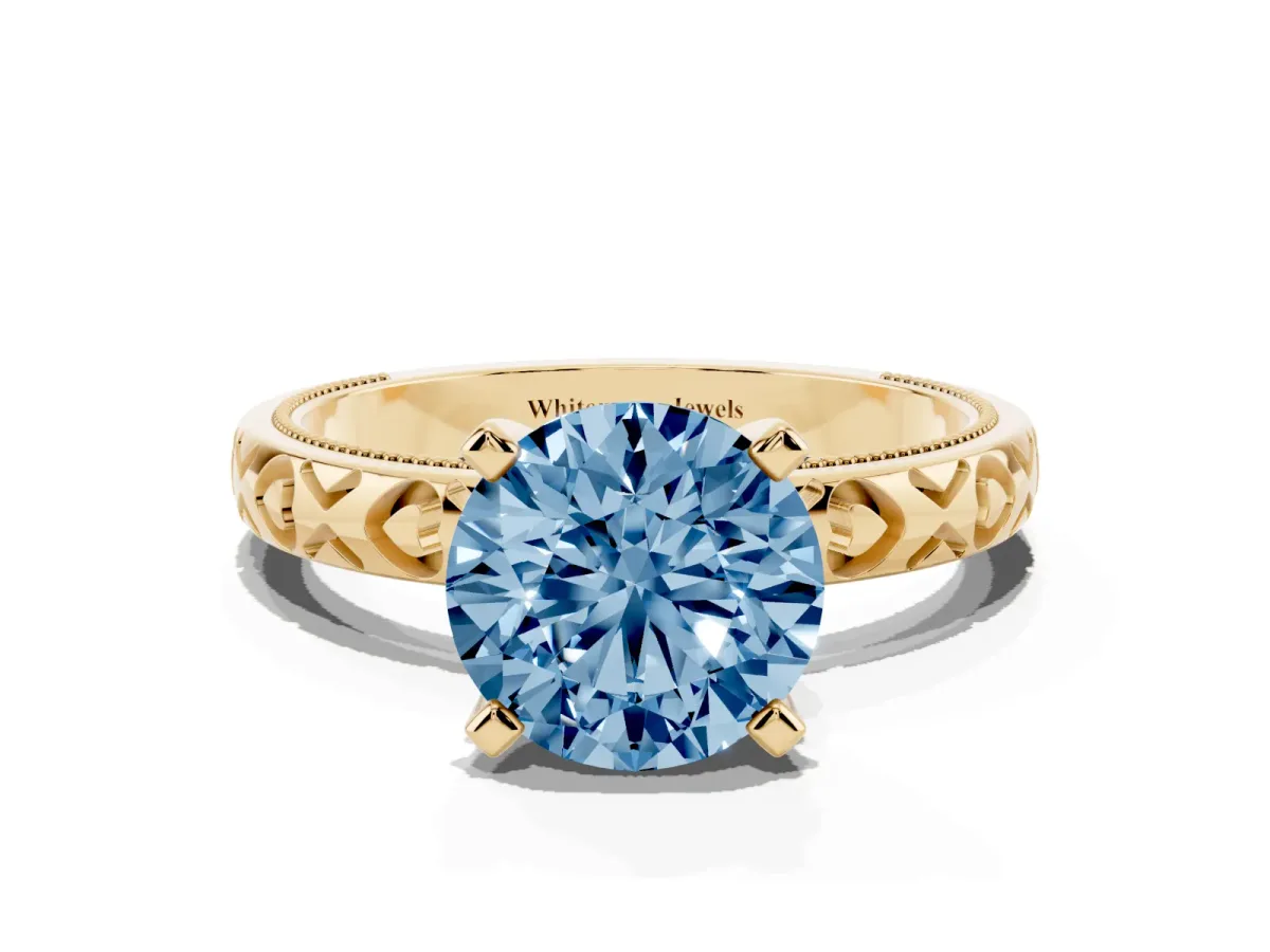 Fancy Blue Round Cut Solitaire Diamond Engagement Ring with XO Engraved Band and Four-Prong Setting Yellow gold