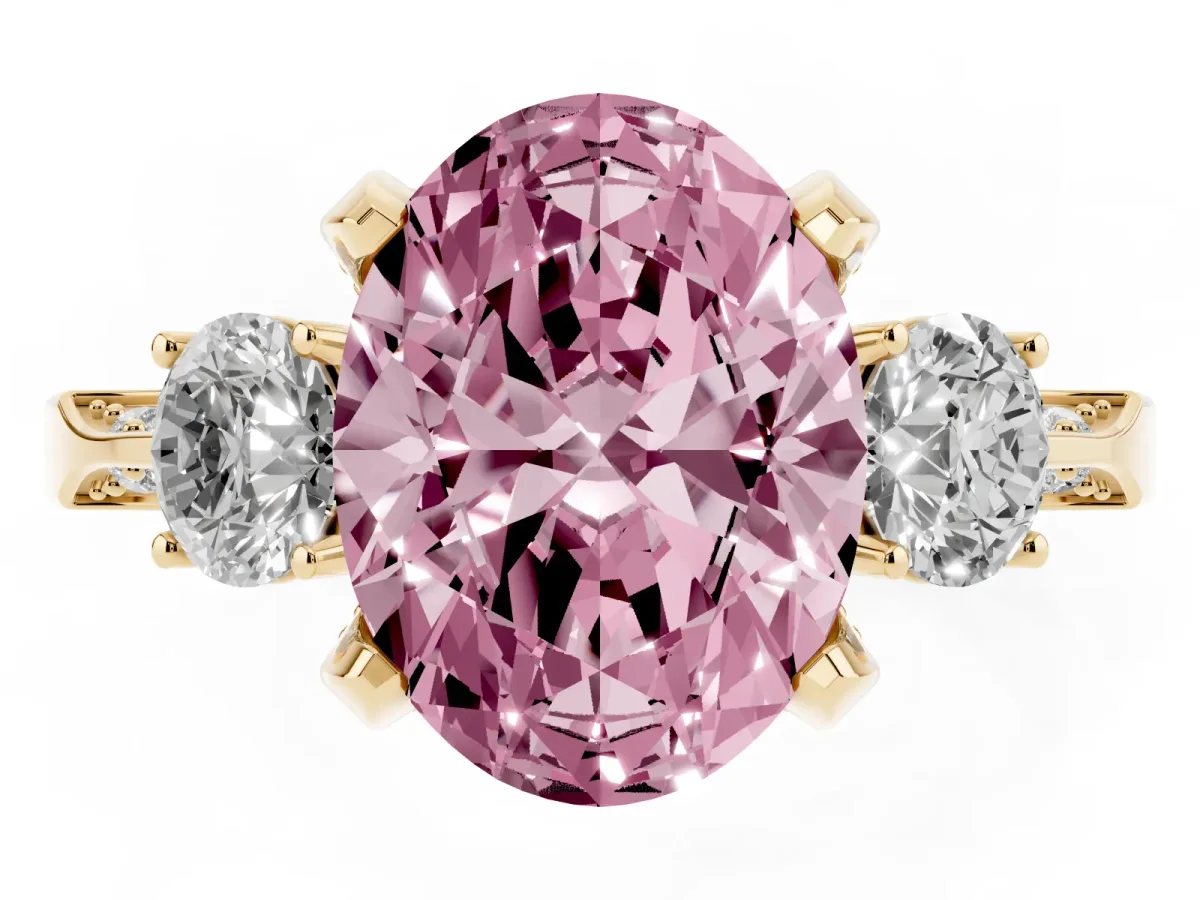 Fancy Pink Oval Cut Brilliant Three-Stone Diamond Ring with Pavé Band and Four-Prong Setting Yellow gold