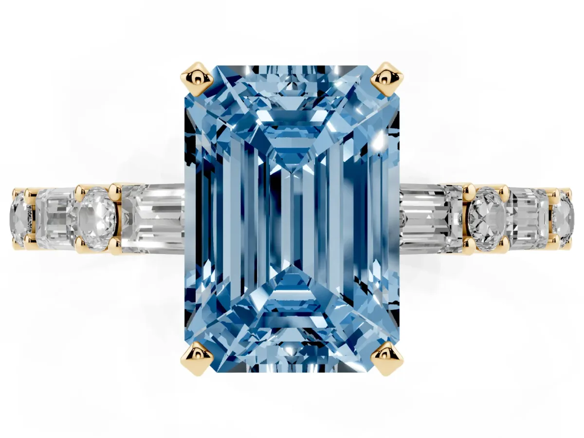Fancy Blue Emerald Cut Diamond Solitaire with Side Baguettes and Channel Set Band Yellow gold