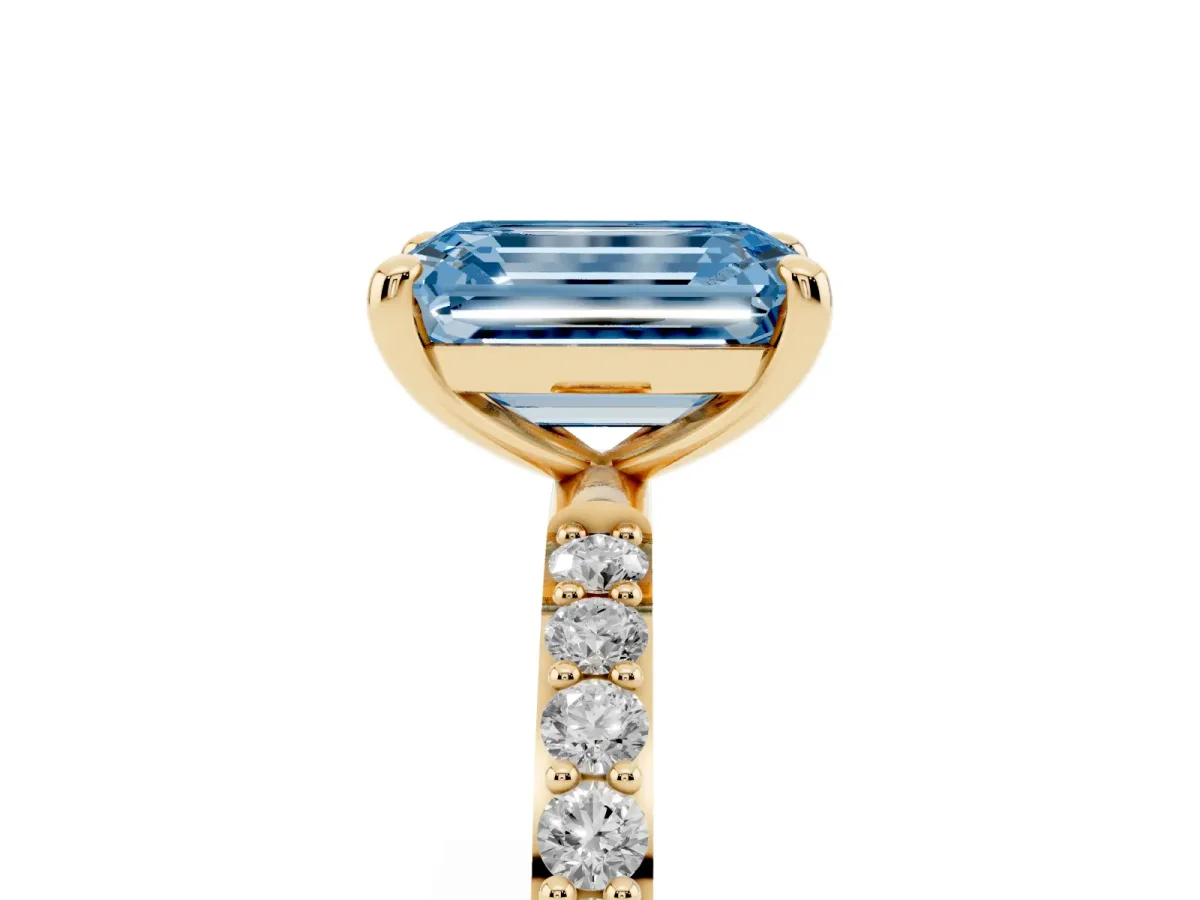 Fancy Blue Emerald Cut Diamond Solitaire Ring with Round Pavé Band and Prong Setting Yellow gold