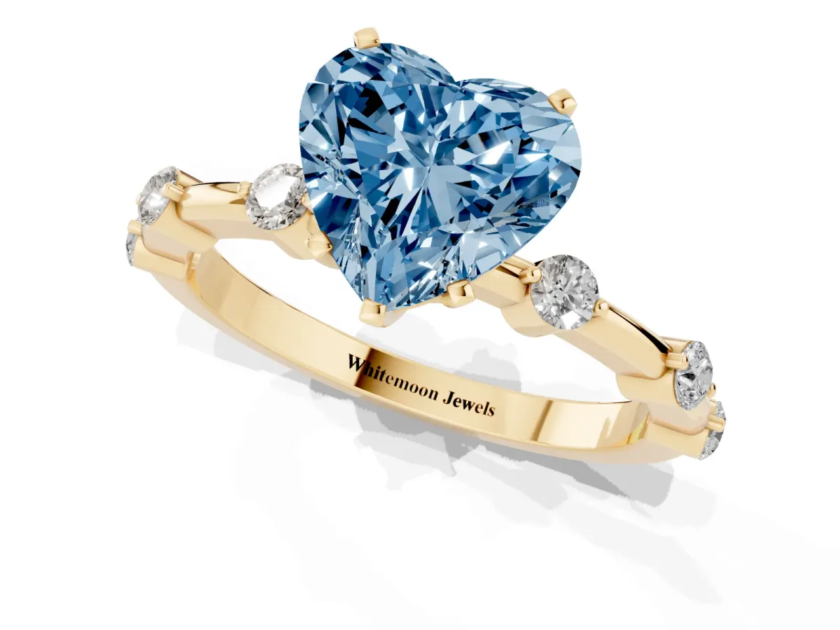 Fancy Blue Heart Cut Solitaire Diamond Ring with Bezel Set Side Stones and Prong Setting Yellow gold
