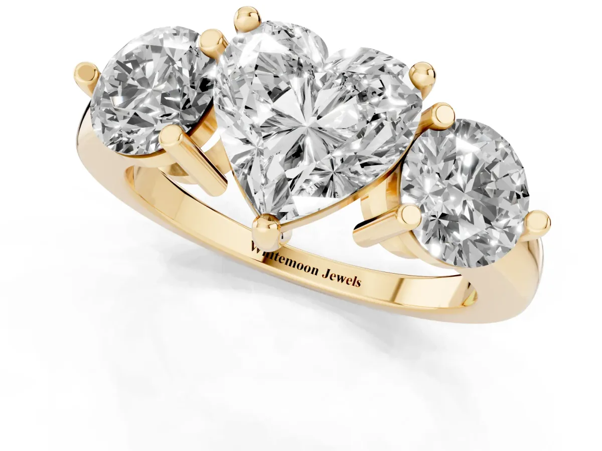 Three-Stone Heart Cut Brilliant Cut Solitaire Ring with Prong Setting on a Classic Band Yellow gold