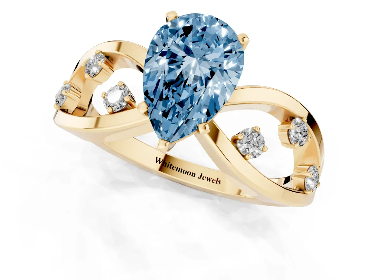 Fancy Blue Pear Cut Cut Solitaire Diamond with Side Stones on Criss-Cross Band and Four-Prong Setting Yellow gold