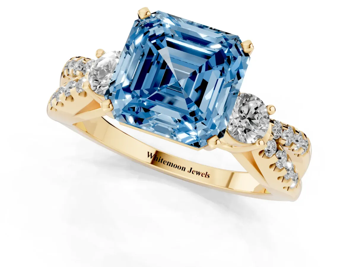 Fancy Blue Asscher Cut Diamond Three-Stone Ring with Pavé Split Shank and Four-Prong Setting Yellow gold