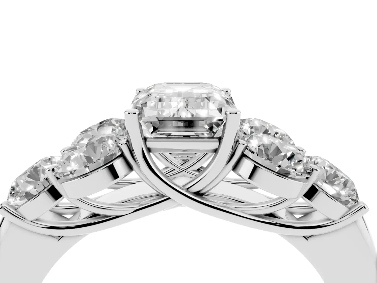 Emerald Cut Cut Diamond Cluster Ring with Round Accent Stones and Prong Setting on a Classic Band Silver