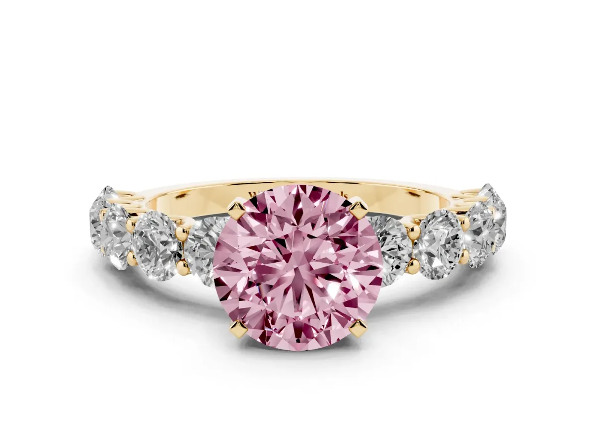 Fancy Pink Round Cut Diamond Prong Setting with Side Stones on a Pave Band Yellow gold