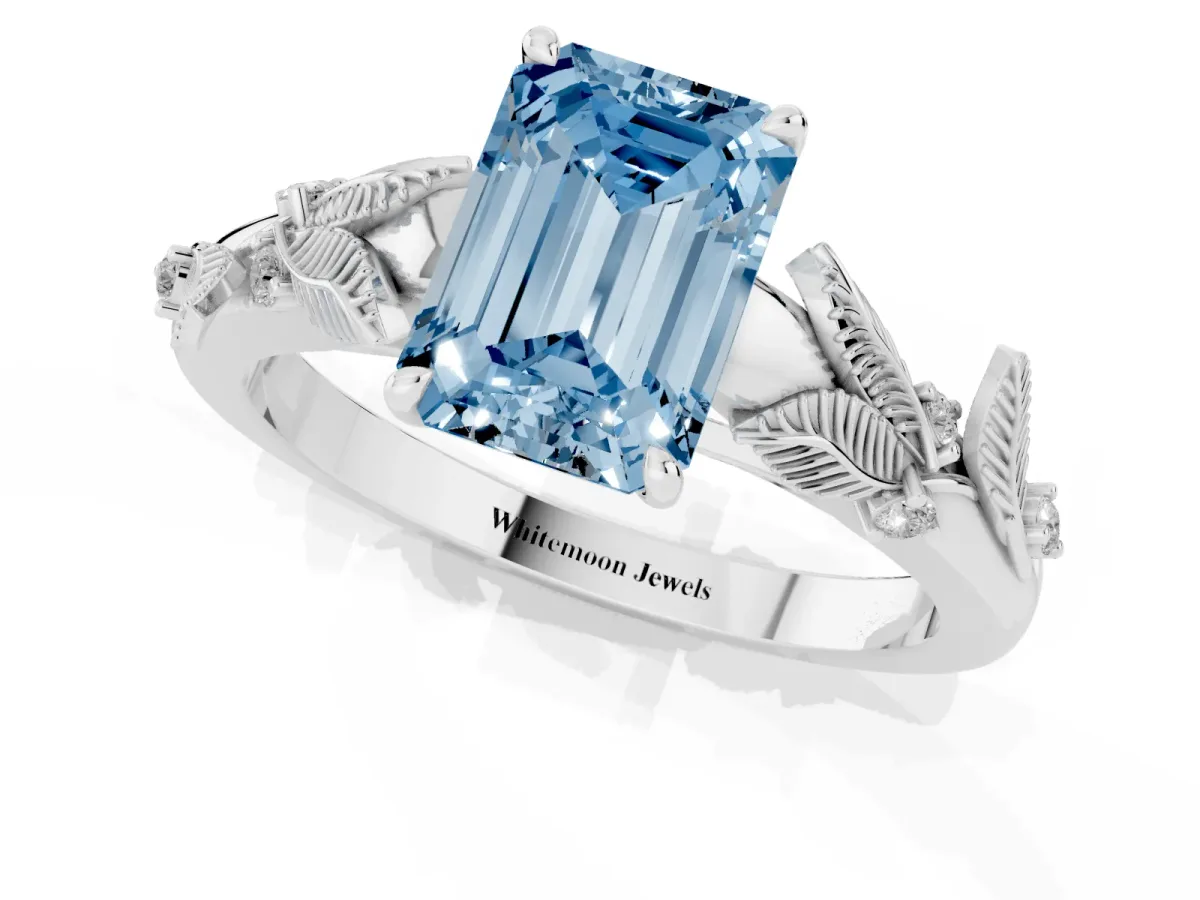 Fancy Blue Emerald Cut Diamond Solitaire Ring with Leaf Motif Band and Four-Prong Setting Silver