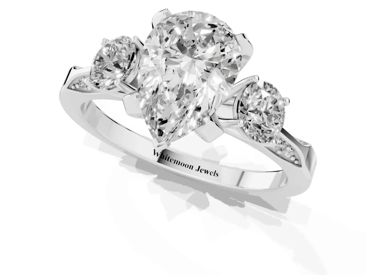Pear Cut Brilliant Three-Stone Diamond Ring with Pavé Band and Four-Prong Setting Silver