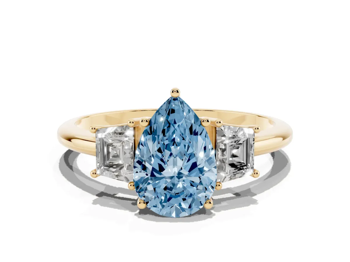 Fancy Blue Pear Cut Diamond Three-Stone Ring with Trapezoid Side Stones and Prong Setting Yellow gold